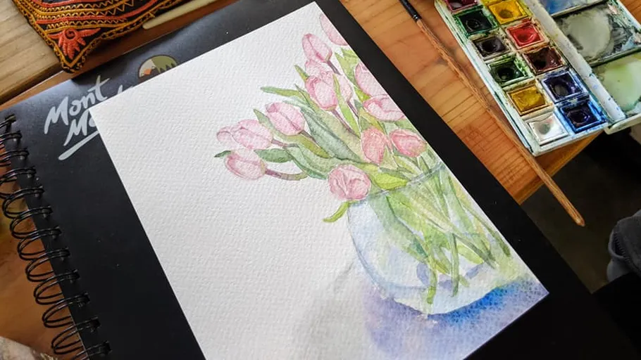 Watercolor painting of tulips in a vase on a table.