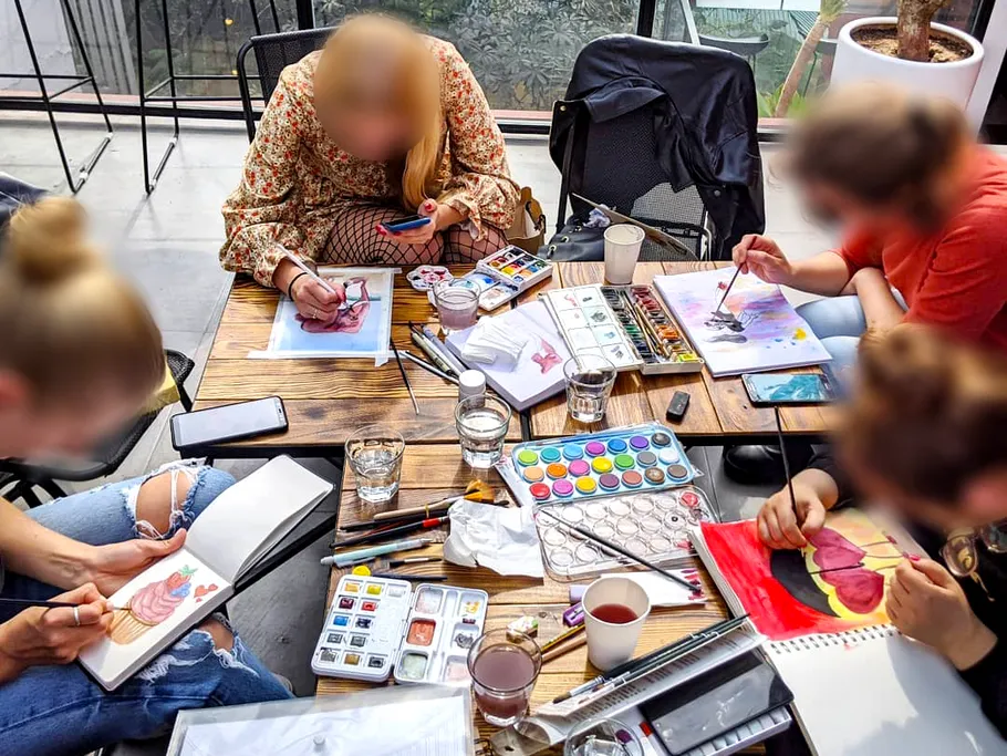 Group painting at table with watercolors.