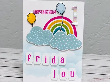 Birthday card features colorful elements, celebrates a first birthday