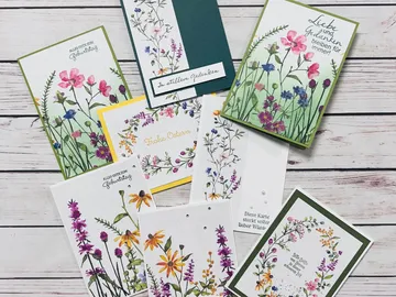 Cards with floral motifs lie on a table.
