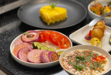 Various fresh foods arranged on a kitchen table.