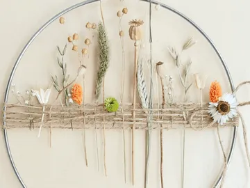 Frame with colorful, dried flowers on jute string.