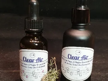 Two bottles of liquid on a black background.