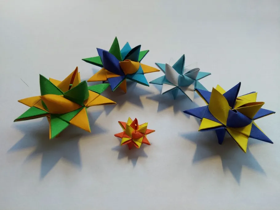 Colourful paper stars are spread over a light background.