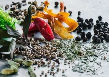 Herbs and spices are arranged on a surface.