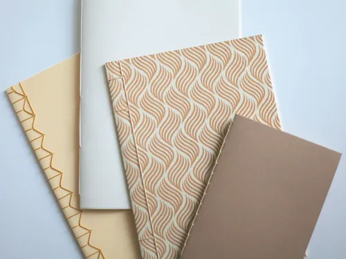 A variety of color cards are laid out on a white table.