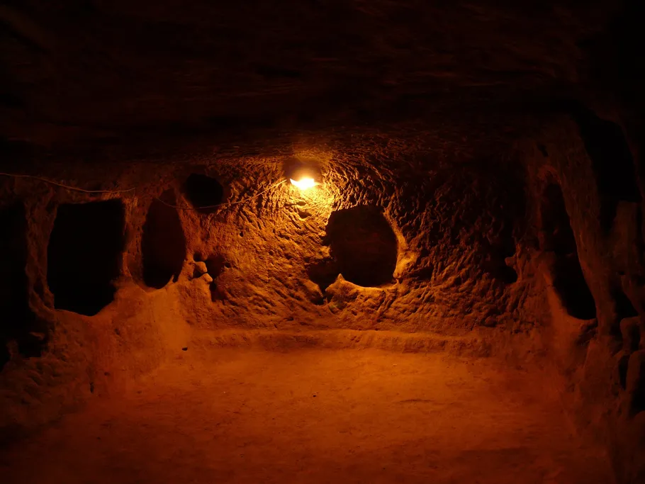 Dark cave with soft lighting and irregular walls.