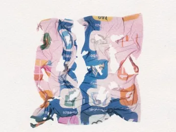 A crumpled paper with colorful logos and colors.