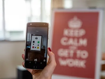 Cell phone shows colorful objects of art in the office.