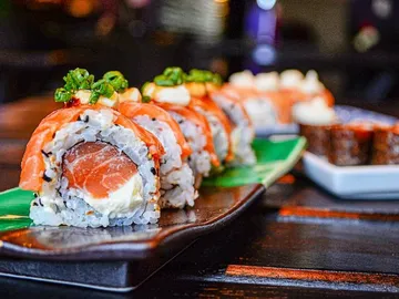 Sushi rolls on a plate served in a restaurant.