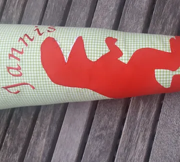 Colourful wrapping paper with the name `Jannis` on it.