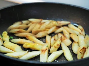 Fry french fries in a pan on the stove.