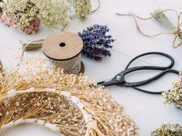 Dried flowers and scissors arranged on a table.