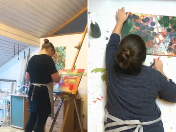Artist paints on a canvas in a studio environment.