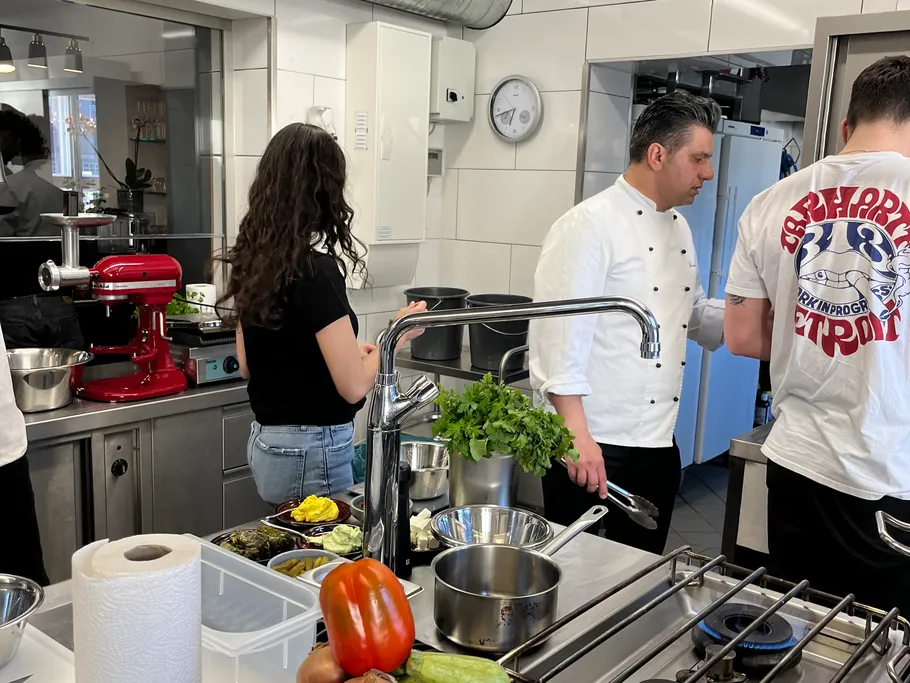 Chefs prepare fresh ingredients in a modern kitchen.