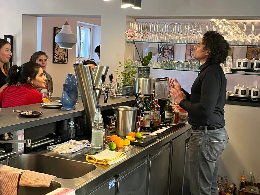 A bartender explains something behind the bar in a pub.