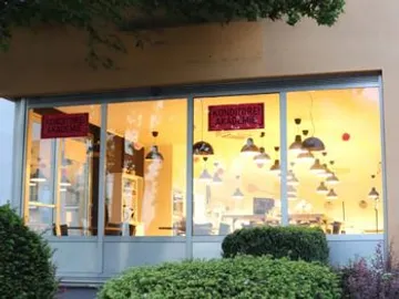 Confectionery with illuminated interior and hanging lamps.