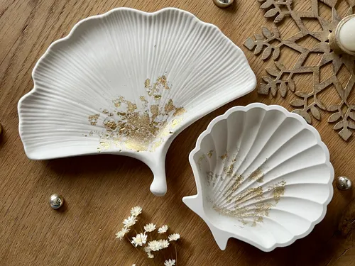 White mussel shells lie on a wooden background.