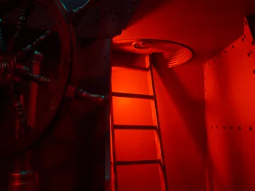 Steuerrad dreht sich in einem rot beleuchteten Raum.