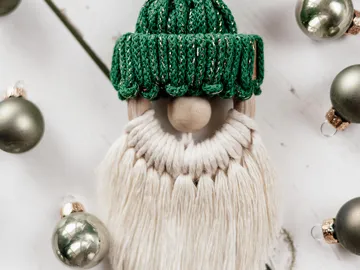 Santa Claus figurine with green cap surrounded by balls