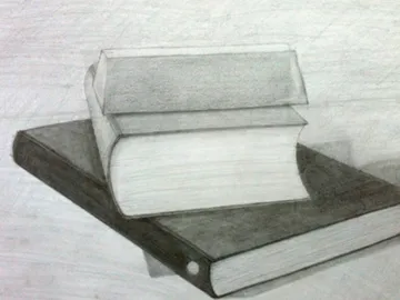 Books lie on top of each other on a table.