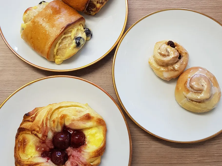 Assorted pastries on plates on a table.