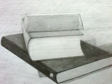Two books lie one above the other on a table.