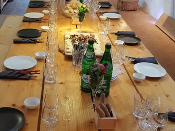 Long table, covered with dishes and drinks for guests