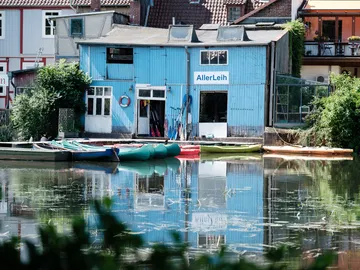 Blue house on the water with equipment rental.