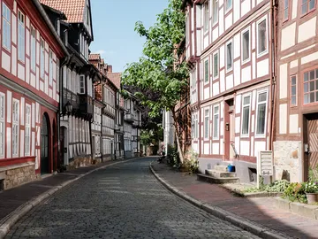 Nice old town street with half-timbered houses and trees.
