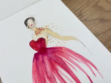 Ein Kleidungsdesign zeigt eine elegante Frau in einem roten Kleid.