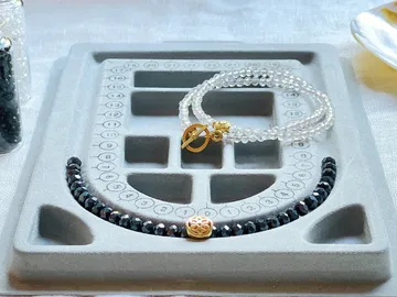 Jewelry is placed on a textured board in a table.