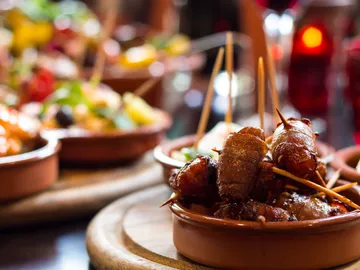 Colourful tapas dishes on a table, focusing on food.