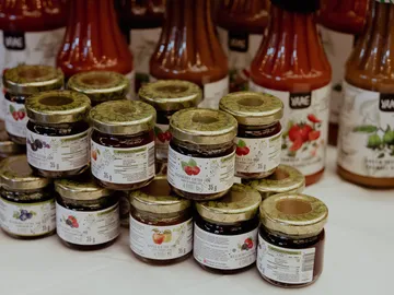 Jars of marmalade are on a table.