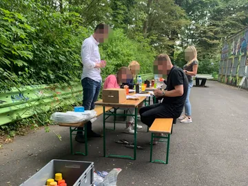 Table with people using drinks and materials.