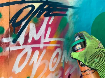 A spray can is used to create colorful graffiti.