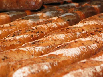 Breads are in a bakery, freshly baked and warm.
