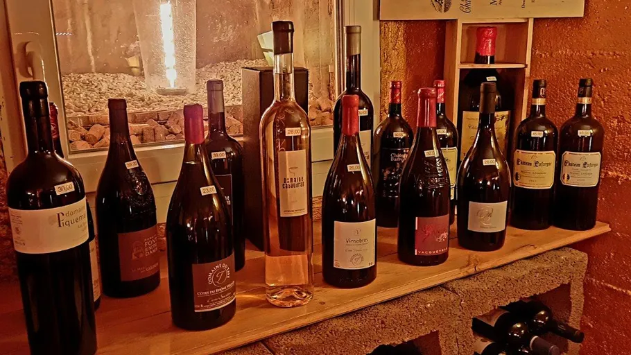 Various wine bottles displayed on a wooden shelf.