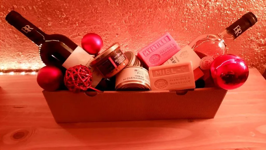 Gift basket with wine, canned food, soap, and ornaments.
