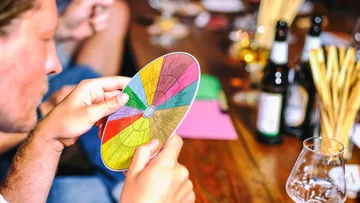 Person holds colored disk that shows various taste elements.