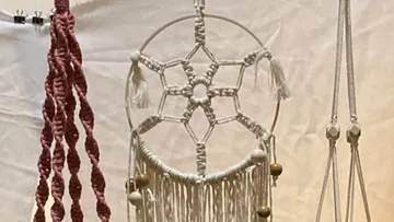 Dreamcatcher hangs, braided with tassels and beads.