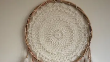 Dreamcatcher hangs on the wall and looks decorative.