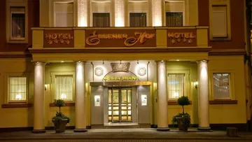 Hotel building with illuminated entrance and restaurant sign.