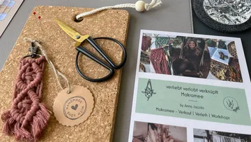 Cork board with scissors, macrame and workshop information sheet.