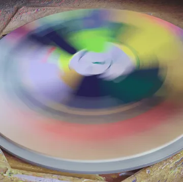 A colorful record rotates on a record player.