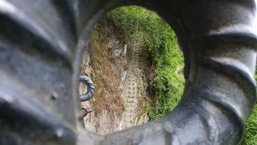 Iron ring frames a steep staircase in a rock wall.