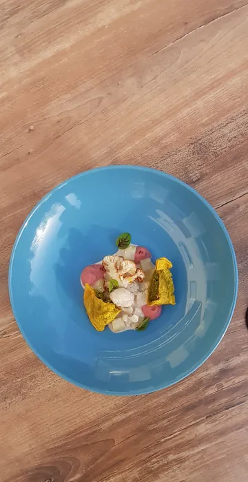 Blue bowl with colorful, creatively prepared food