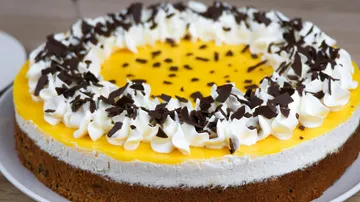 A cake with cream, chocolate and citrus icing.