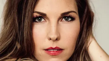 A portrait of a woman with long hair and intense eyes.