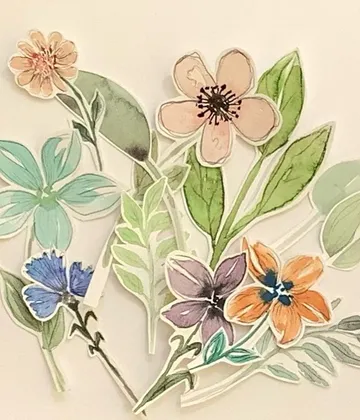 Colorful flowers and leaves arranged on a light background.